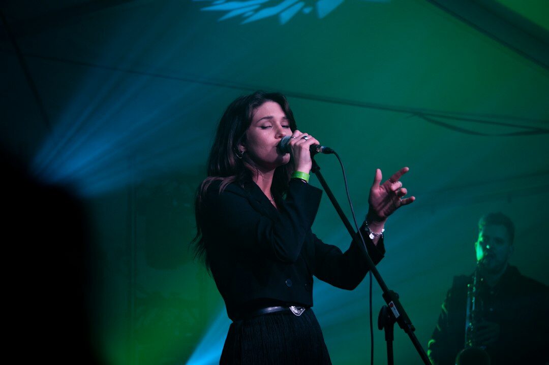 woman singing on stage
