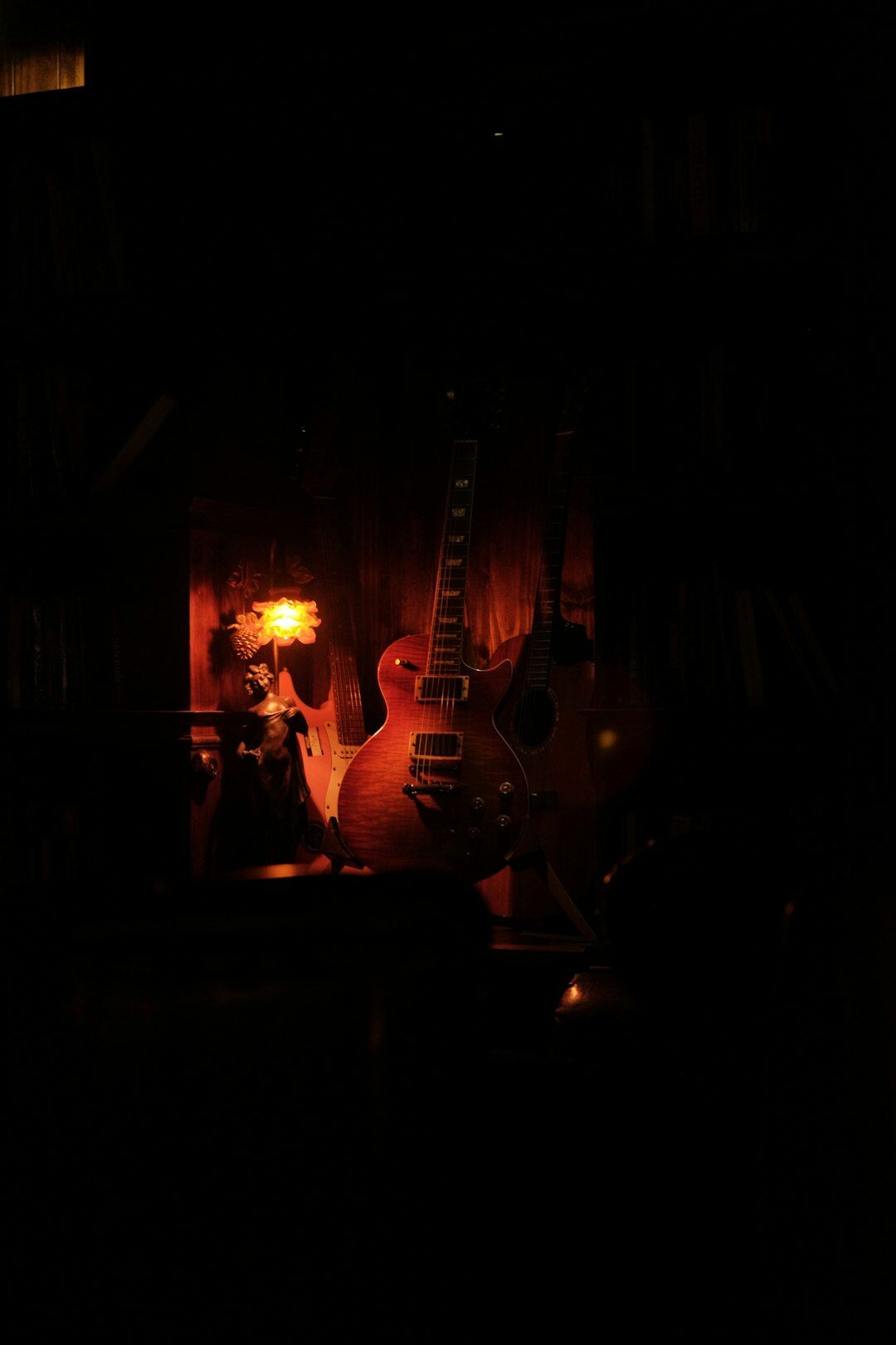 young musician playing guitar in small room